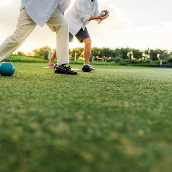 two people playing a game of golf on the grass