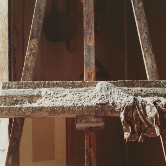 an old wooden chair with a cloth on it