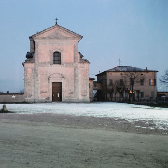 an old church in the snow with the moon