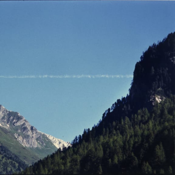 a view of a mountain range and a blue sky