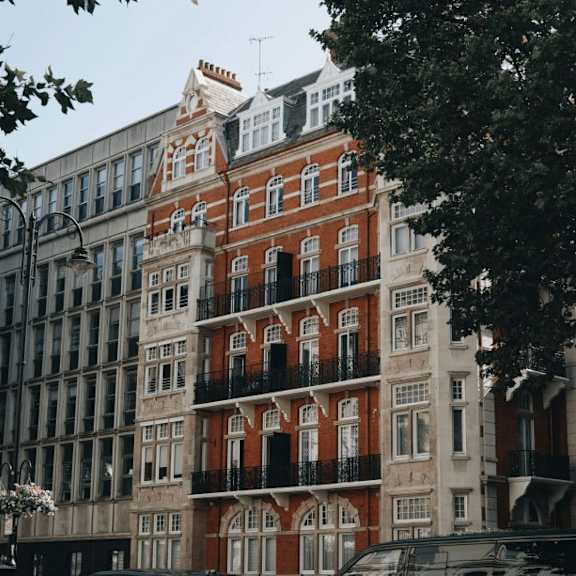 a row of buildings with a red building in the middle.
