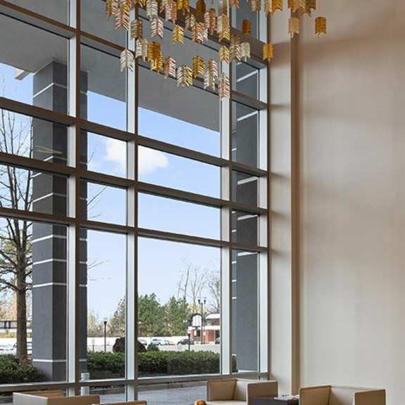 a large room with a long table and chairs and a chandelier hanging from the ceiling.