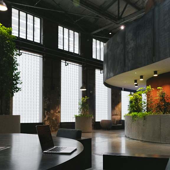 a modern office space with a laptop on a table.