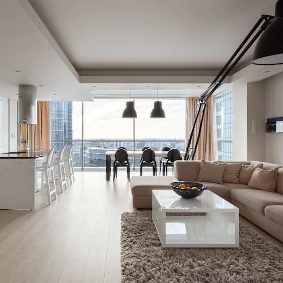 a modern living room with a large window overlooking the city.