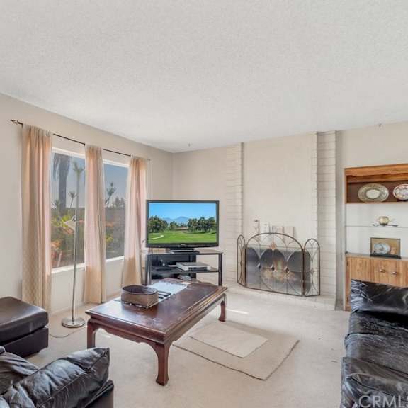 a living room with a brown leather couch and a wooden coffee table.