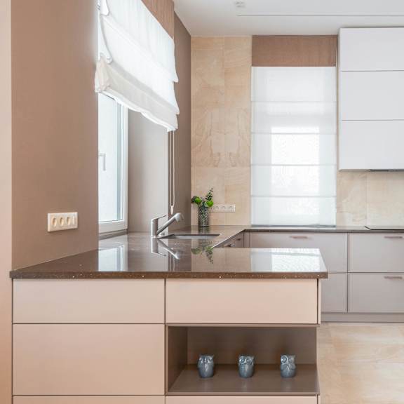 a modern kitchen with a sink, stove, and refrigerator.