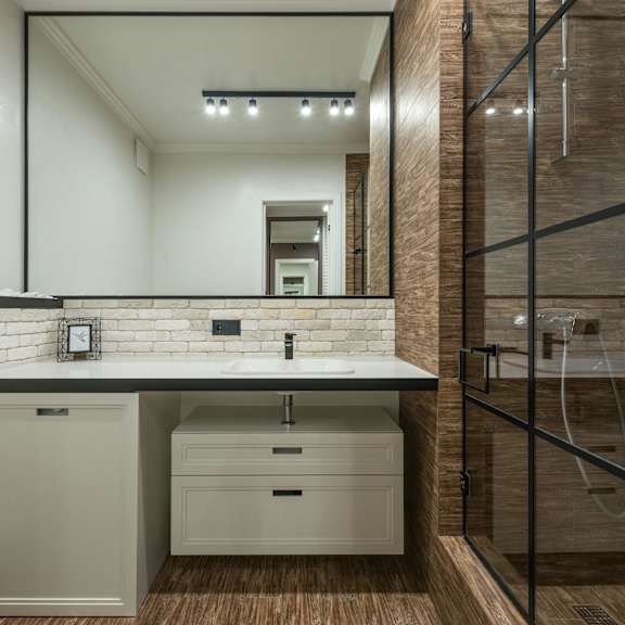 a bathroom with a white countertop and a white sink.