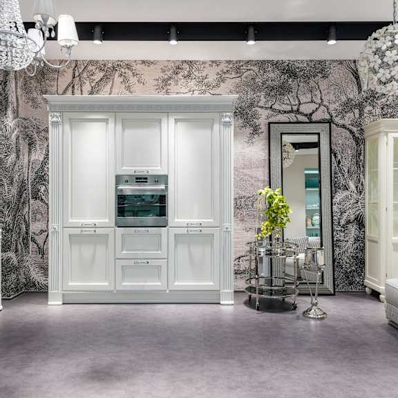 a room with a large white wardrobe and a bed.