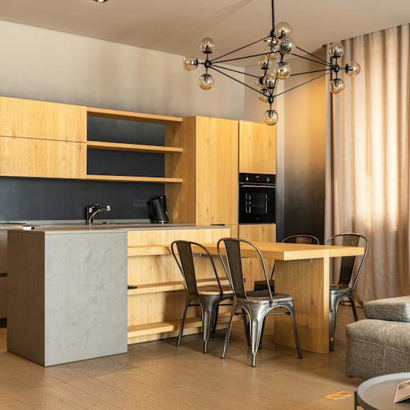 a modern kitchen with a dining table and chairs.
