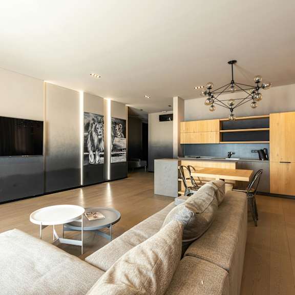 a modern living room with a long couch and a coffee table.