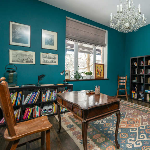 a room with a wooden table and a chandelier.