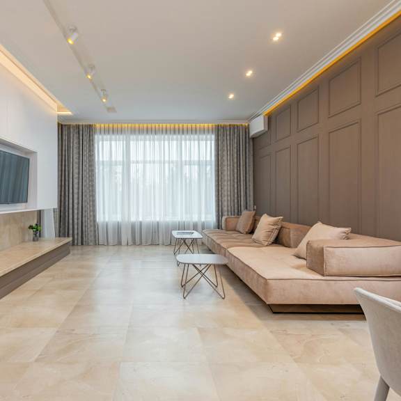 a modern living room with a fireplace and a large couch.