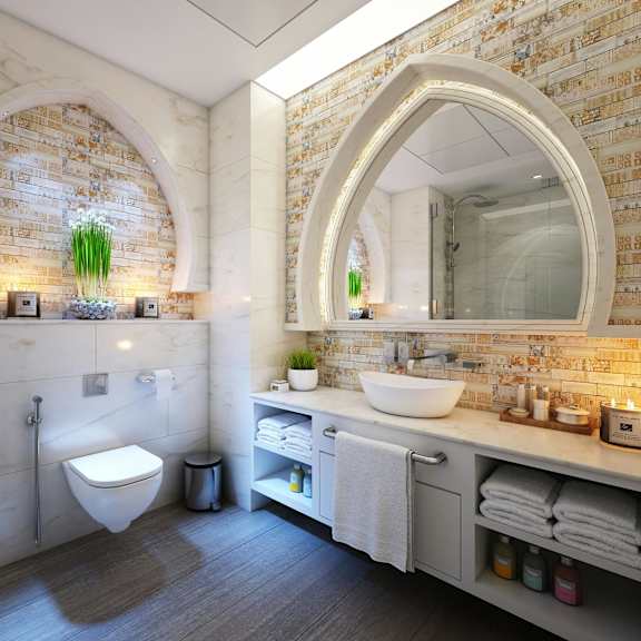 a bathroom with a toilet, sink, and mirror.