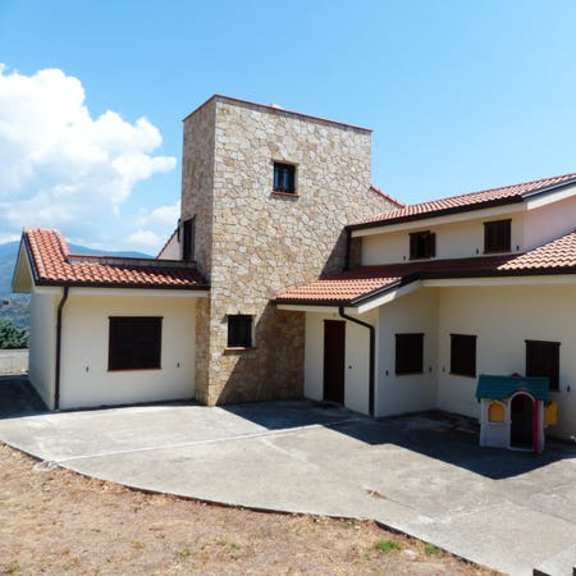 a house with a tower-like structure on the left side.
