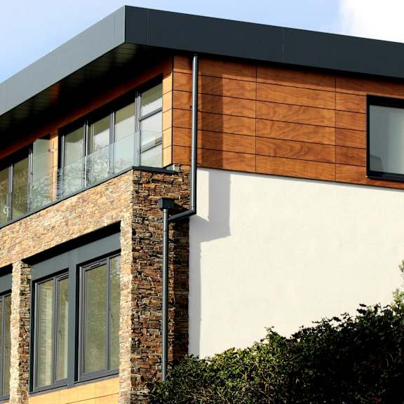 a modern house with a combination of brick and wood siding.