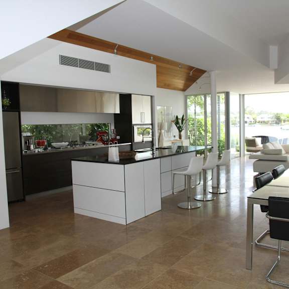 a modern kitchen with a dining table and chairs.
