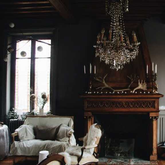 a living room with a fireplace and a chandelier.