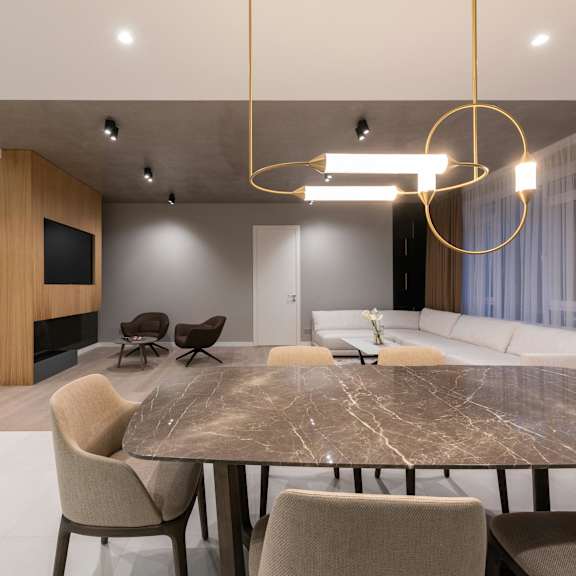 a modern dining room with a large table and chairs.