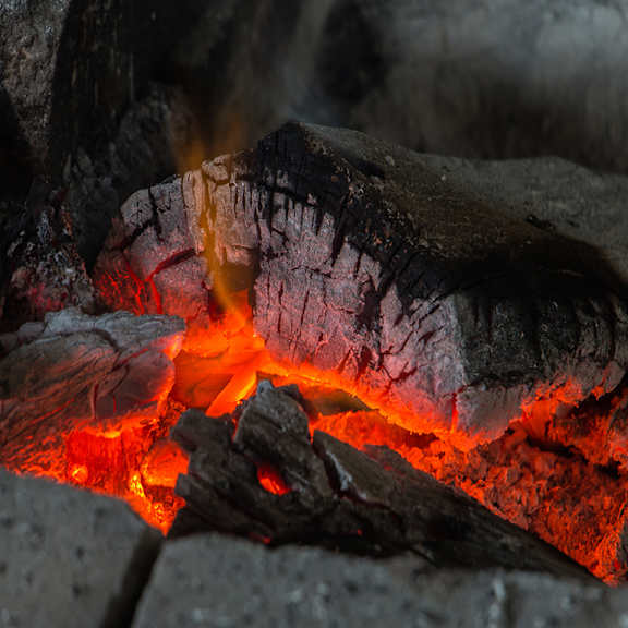 a close up of a fire with bright orange and red flames.