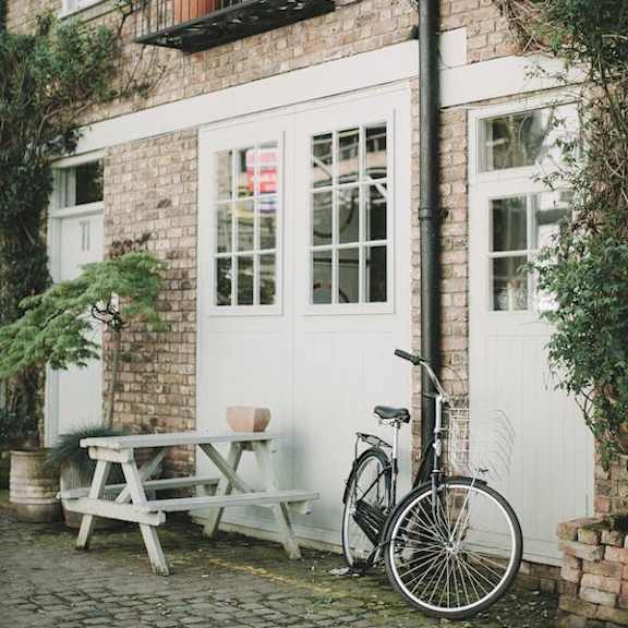 a bicycle is parked next to a white door.