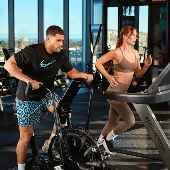 a man and a woman are exercising on elliptical machines in a gym. at cherrywood apartments, d18 vy3v, dublin 18