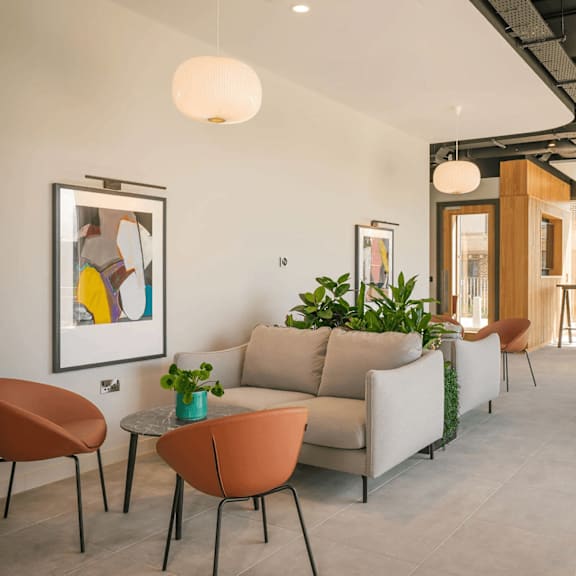 a living room with a couch, chairs, and a potted plant. at cherrywood apartments, d18 vy3v