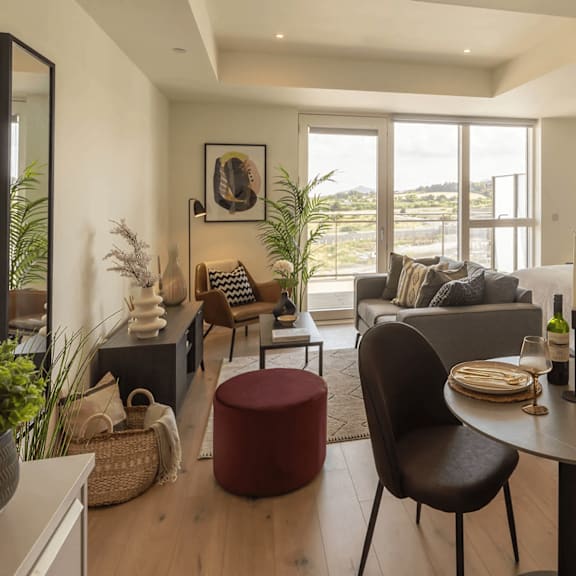 a modern living room with a dining table set for two. at cherrywood apartments, d18 vy3v, dublin 18