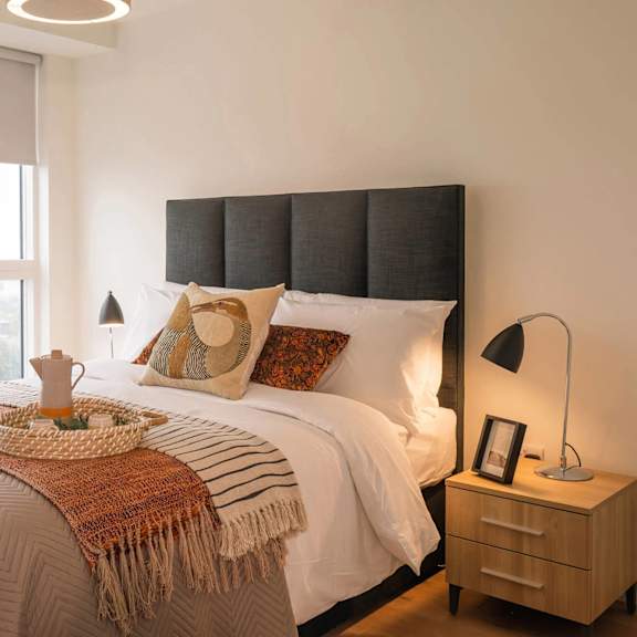 a bedroom with a large bed and a window overlooking a cityscape. at cherrywood apartments, d18 vy3v, dublin 18