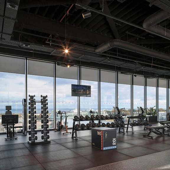 a gym with a view of the city. at cherrywood apartments, d18 vy3v