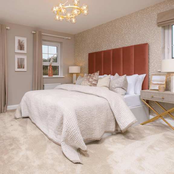 a bedroom with a large bed and a chandelier.