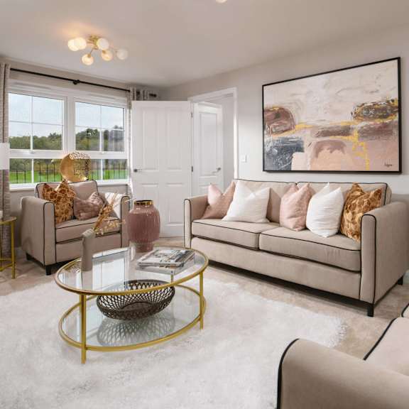 a living room with a sofa, two chairs, and a coffee table.