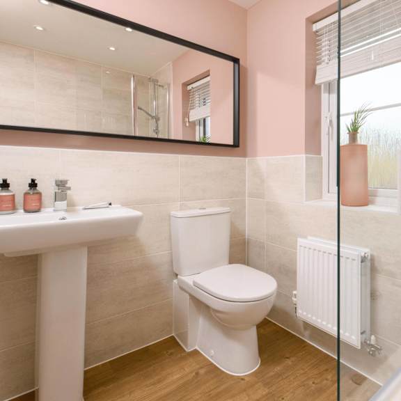 a white toilet sits next to a sink in a bathroom.
