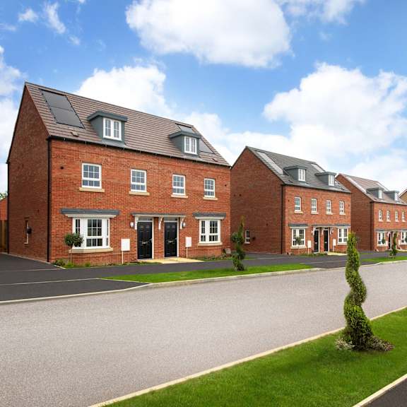 a row of red brick houses with black doors and windows.