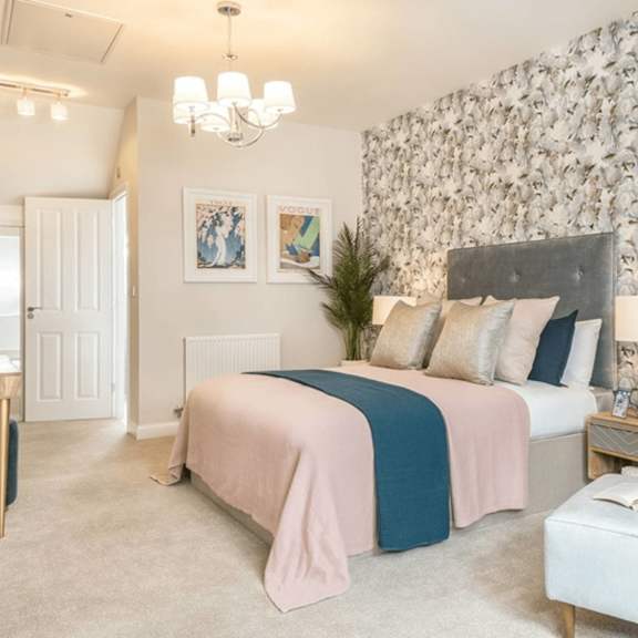 a bedroom with a large bed and a chandelier.