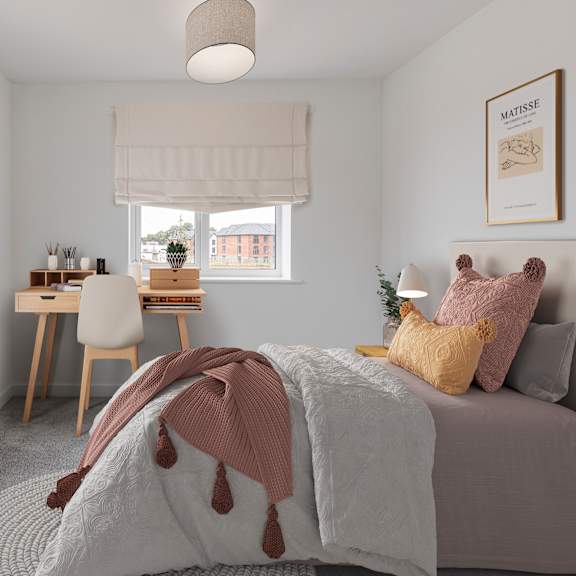 a bedroom with a bed, desk, and window.