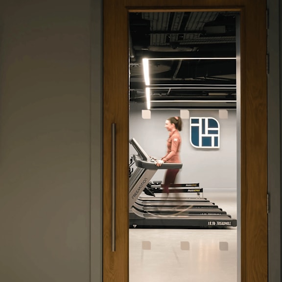a woman is running on a treadmill in a gym. at cherrywood apartments, d18 vy3v, dublin 18