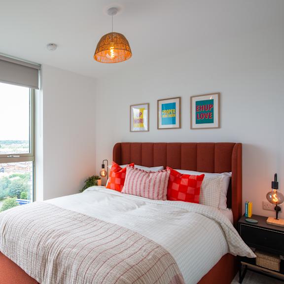 Thumbnail 6 of 8 A bedroom with a large bed and a view of the city.