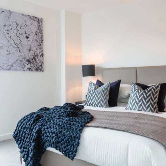 Thumbnail 2 of 7 a bedroom with a bed and a large window at Vox Apartments, Manchester, M15 4YD