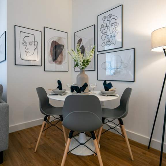 Thumbnail 3 of 6 a dining room with a table and chairs and a lamp at The Keel Apartments, Liverpool
