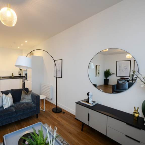Thumbnail 6 of 8 a living room with a couch and a mirror at The Keel Apartments, Liverpool