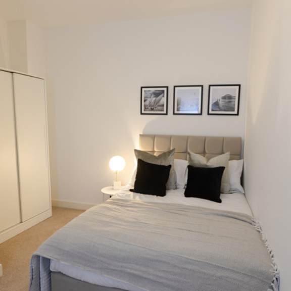 Thumbnail 2 of 8 a bedroom with a bed and three pictures on the wall at The Keel Apartments, Liverpool, L3 4GE