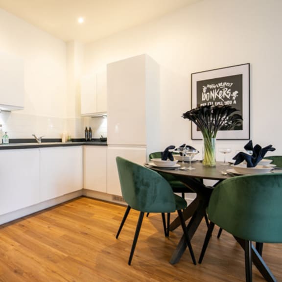 Thumbnail 4 of 6 a kitchen and dining area with a table and chairs at The Keel Apartments, Liverpool
