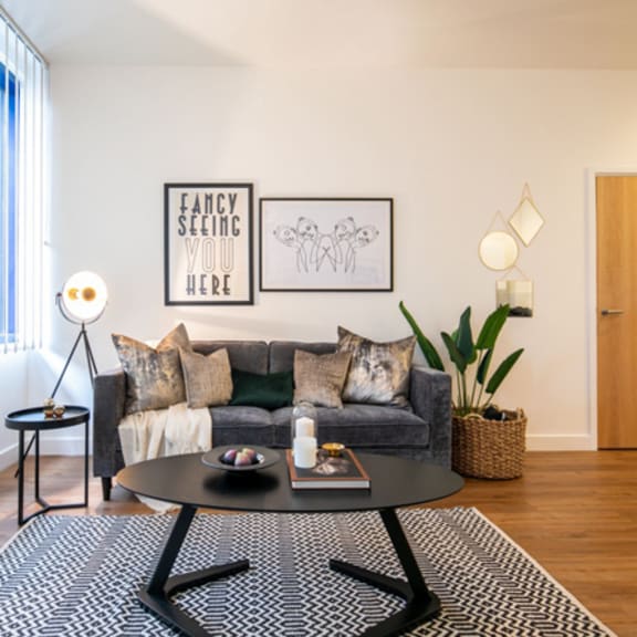 Thumbnail 3 of 6 a living room with a couch and a coffee table at The Keel Apartments, Liverpool
