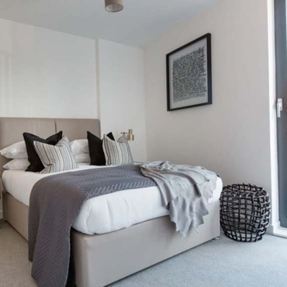 Thumbnail 1 of 5 a bedroom with a large bed and a window at Vox Apartments, Manchester