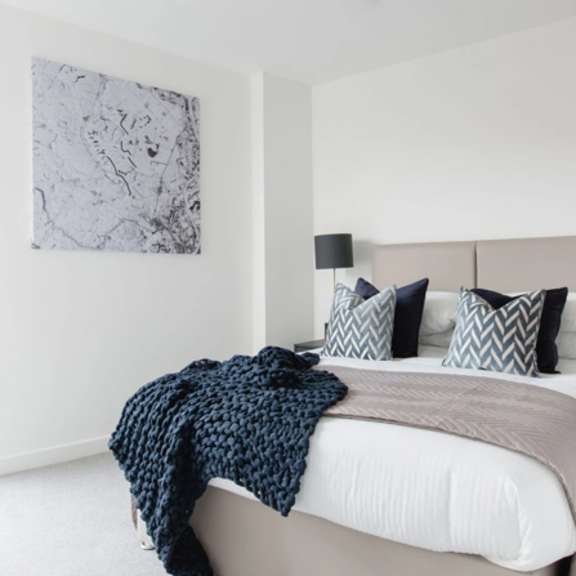 Thumbnail 2 of 8 a bedroom with a bed and a large window at Vox Apartments, Manchester, M15 4YD