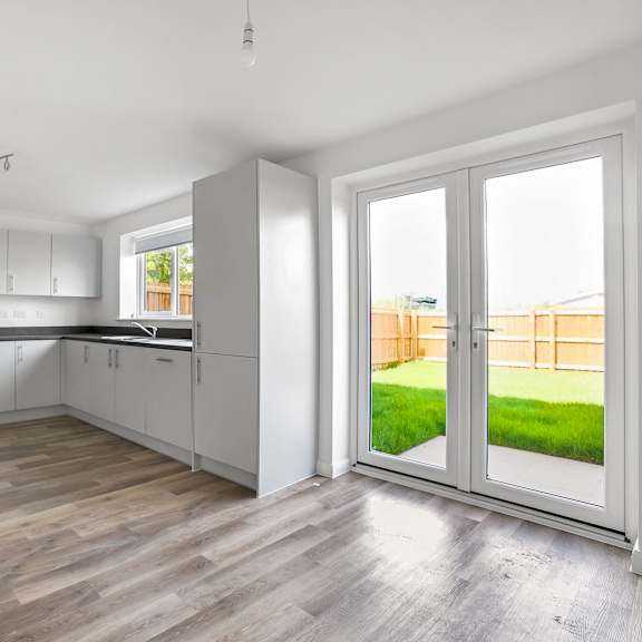 Thumbnail 1 of 5 a kitchen with white cabinets and a sliding glass door