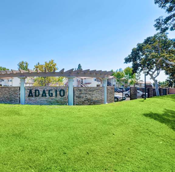 A wall with the word "ADAGIO" painted on it in white letters.