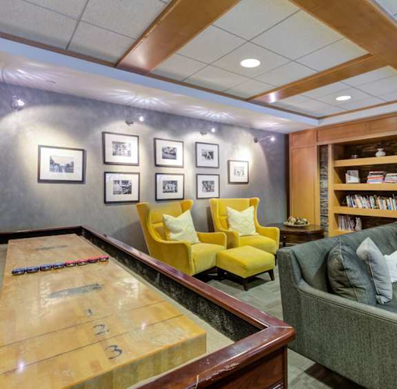 A shiny table with numbers on it is in the middle of a room with a couch and chairs.
