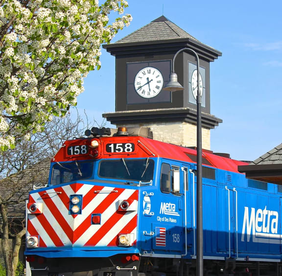 a train is parked in front of a clock tower