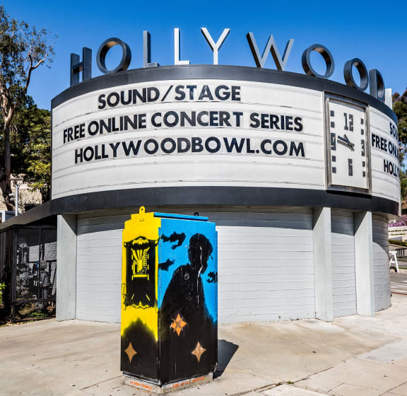 a building with a hollywoodollywood sign and a yellow fire hydrant